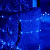 Blue string lights wrapped around a wooden planter with succulents. Náhľad obrázku produktu