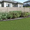 A garden fence with plants in front of a house. Produktbild-Vorschau