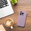 A flat lay of a laptop, a cup of coffee with latte art, and a purple phone case on a wooden surface. Produktbild-Vorschau