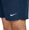 A close-up shot of a man's legs wearing navy blue Nike swim shorts. Podgląd zdjęcia produktu