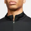Close-up of a person wearing a black jacket with white stripes on the shoulder. Produktbild-Vorschau