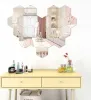 A vanity table with makeup and perfume, with a wall decorated with hexagonal mirrors. Náhled obrázku produktu