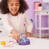 A young girl is playing with a toy car and a cat figure. Anteprima dell’immagine prodotto