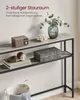 A narrow console table with two shelves, displaying decorative items and storage boxes. Produktbild-Vorschau