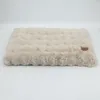 A beige plush dog bed with a textured surface is shown against a white background. Anteprima dell’immagine prodotto