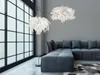 A modern living room with a sectional sofa, a floor lamp, and a pendant light. Produktbild-Vorschau