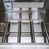 Close-up view of the interior of a gas grill, showing the burners and heating elements. Náhled obrázku produktu