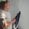 A man is using a drywall taping tool in a corner of a room. Náhľad obrázku produktu
