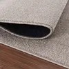 A close-up view of a rug, showing its texture and the underside where it is rolled. Podgląd zdjęcia produktu
