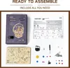 A flat lay of a ROKR 3D wooden puzzle kit for a 'Starry Night' mechanical music box, showing the box, instructions, and all components. Voir les images du produit