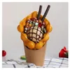 A bubble waffle ice cream cone with toppings. Podgląd zdjęcia produktu