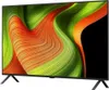 A television set with a colorful abstract image displayed on its screen, shown from a slightly angled front view with its stand visible. Produktbild-Vorschau