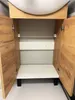 The interior of an open bathroom cabinet with wooden doors. Podgląd zdjęcia produktu
