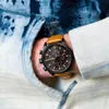 A close-up shot of a person's wrist wearing a Timberland watch, with part of their clothing visible. Náhled obrázku produktu