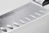 A close-up shot of a Wusthof Classic Ikon Santoku knife blade. Voir les images du produit