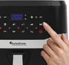 A close-up of the control panel of a black air fryer, with a finger pressing a button. Produktbild-Vorschau
