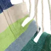 A close-up view of a striped hammock made of fabric. Náhled obrázku produktu