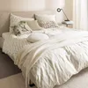 A neatly made bed with patterned bedding and several decorative pillows. Anteprima dell’immagine prodotto
