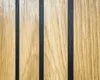 A close-up view of a wooden surface with vertical black stripes. Produktbild-Vorschau