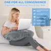 A woman is sitting on a bed using a laptop on a U-shaped pillow. Produktbild-Vorschau