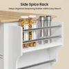 A close-up view of a white kitchen cart with a wooden top, featuring a side spice rack with spice jars and grinders. Podgląd zdjęcia produktu
