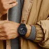 A person wearing a watch on their wrist. Produktbild-Vorschau