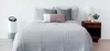 A bedroom scene with a bed, an air purifier, and a nightstand. Anteprima dell’immagine prodotto