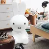 A child's bedroom with a large Miffy lamp, toys, and a bed. Produktbild-Vorschau