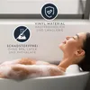 A woman relaxing in a bathtub with a bath mat. Produktbild-Vorschau