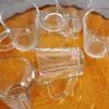 Several clear glass mugs are arranged on a textured orange surface. Náhľad obrázku produktu