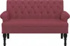 A studio shot of a burgundy loveseat with tufted backrest and black legs. Produktbild-Vorschau