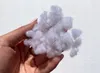 A hand holding a clump of white stuffing material. Anteprima dell’immagine prodotto