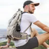 A man wearing a backpack and sitting outdoors. Voir les images du produit