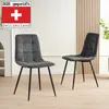 Two dark gray upholstered dining chairs with black metal legs are shown in a room with a light-colored wall and wooden paneling. Náhled obrázku produktu
