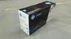 A box of HP toner cartridge is placed on a concrete floor. Voir les images du produit