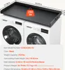 A black countertop placed on top of two white washing machines. Náhled obrázku produktu