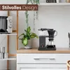 A coffee maker on a kitchen counter next to a plant and microwave. Produktbild-Vorschau