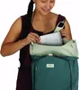 A woman is placing a laptop into an Osprey backpack. Produktbild-Vorschau