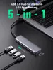 A USB hub and its accessories are shown connected to a laptop. Produktbild-Vorschau