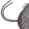A close-up of a textured cushion with two drawstrings and a small label attached. Podgląd zdjęcia produktu