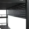 Close-up view of the underside of a metal bunk bed frame, showing a perforated panel and shelving. Produktbild-Vorschau