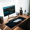 A clean and organized desk setup with a computer monitor, keyboard, mousepad, laptop, speakers, and plants. Náhled obrázku produktu