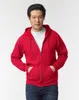 A man wearing a red zip-up hoodie and blue jeans, posing against a white background. Produktbild-Vorschau