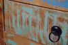 A close-up of a wooden drawer with a distressed painted finish and a metal handle. Produktbild-Vorschau