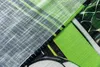 A close-up view of different fabric textures and patterns, with a focus on green and white elements. Produktbild-Vorschau