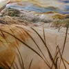 A close-up view of a duvet cover with a beach dune and grass print. Produktbild-Vorschau