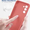 A hand is touching a red phone case, highlighting its matte surface and soft grip. Produktbild-Vorschau