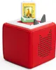 A red Toniebox audio player with a book-shaped Tonie figure on top. Produktbild-Vorschau