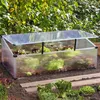 A small greenhouse filled with lettuce and other leafy greens, placed in a garden setting. Náhled obrázku produktu