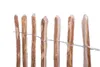 A close-up view of a wooden fence made of natural hazel wood stakes bound together with wire. Produktbild-Vorschau